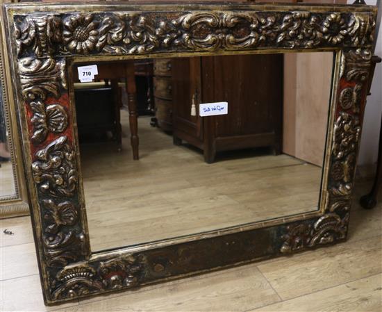 A Florentine style carved and painted giltwood painted wall mirror, 90 x 116cm